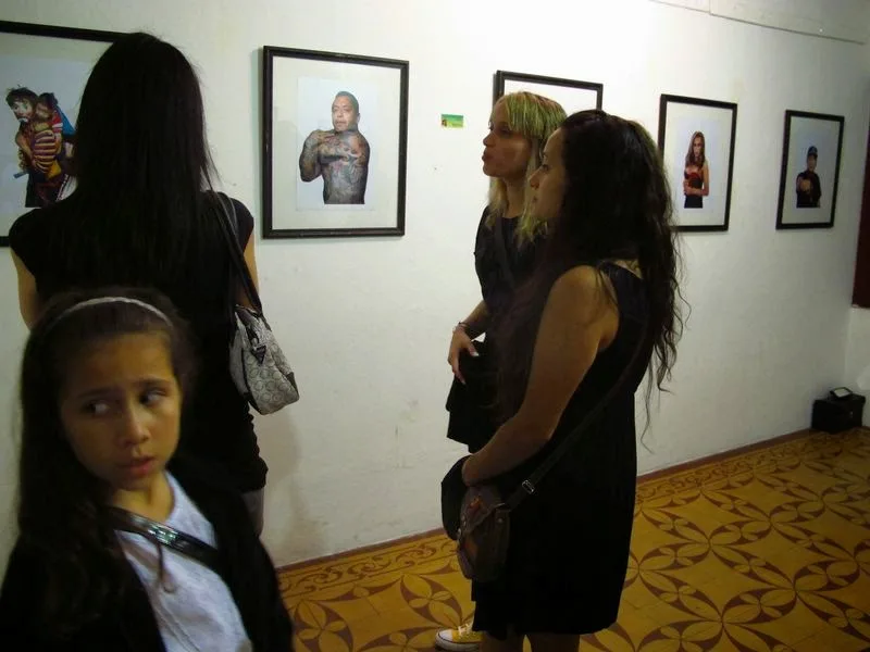 Visitantes recorren una muestra fotográfica del festival de 2013