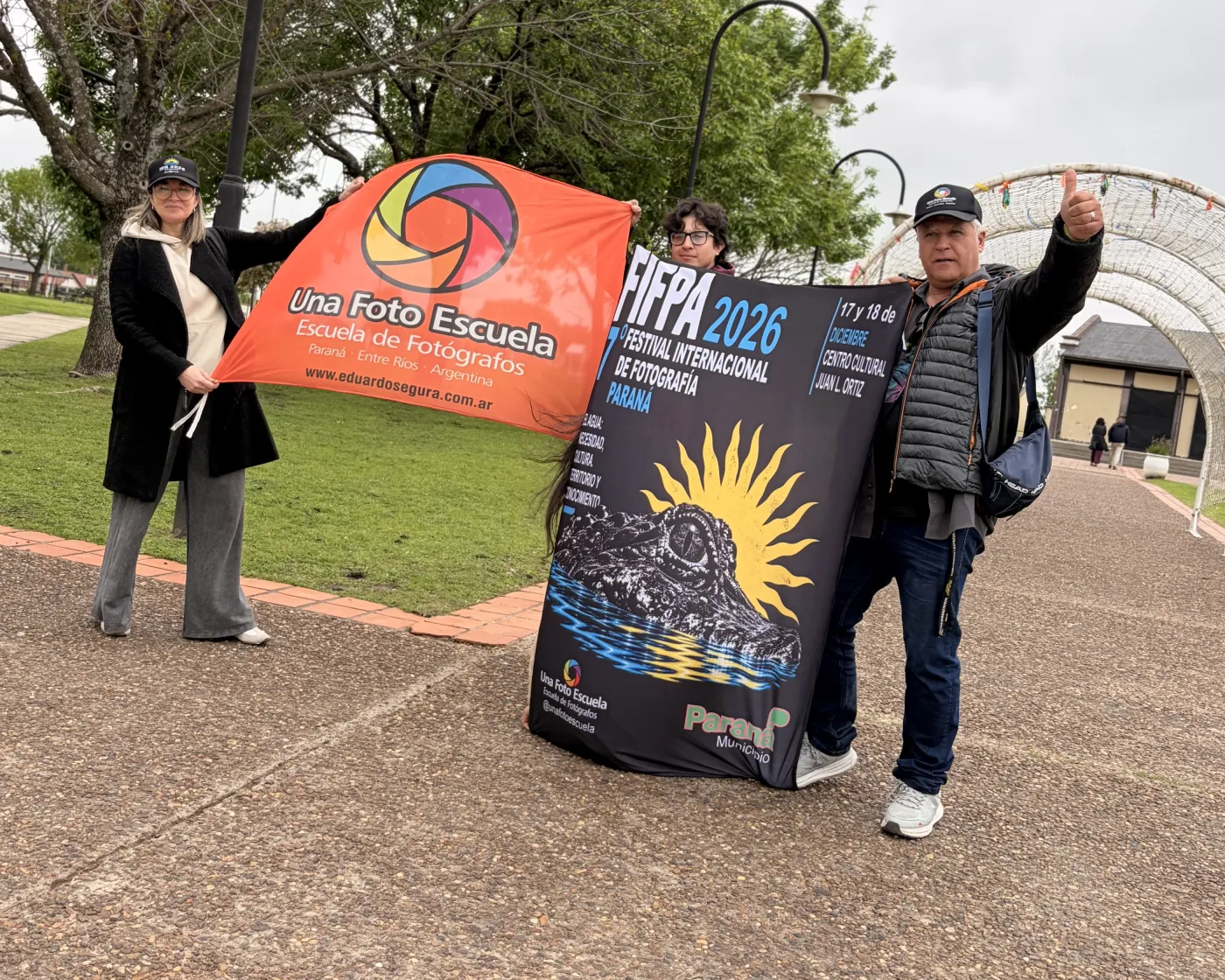Integrantes de Una Foto Escuela y FIFPA con las banderas del festival en Paraná.